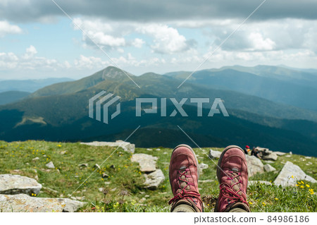 Relax woman feet lying down in the hill, relaxing and looking at mountain view in summer time at camping vacation holiday. Relax woman feet lying down in the hill, relaxing and looking at mountain view in summer time at camping vacation holiday. 84986186