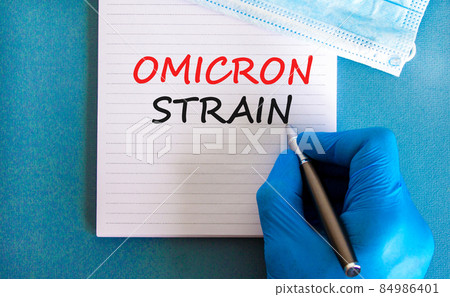 New covid-19 omicron variant strain symbol. Hand in blue glove with white note. Concept words Omicron strain. Metalic pen. Medical and COVID-19 omicron variant strain concept. Copy space. New covid-19 omicron variant strain symbol. Hand in blue glove with white note. Concept words Omicron strain. Metalic pen. Medical and COVID-19 omicron variant strain concept. Copy space. 84986401