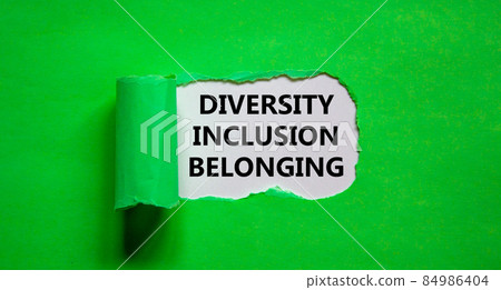 Inclusion and belonging symbol. Words 'diversity, inclusion, belonging' appearing behind torn green paper. Beautiful green background. Business, better inclusion and belonging concept. Copy space. Inclusion and belonging symbol. Words 'diversity, inclusion, belonging' appearing behind torn green paper. Beautiful green background. Business, better inclusion and belonging concept. Copy space. 84986404