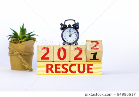 2022 rescue new year symbol. Alarm clock. Turned a wooden cube, changed words 'rescue 2021' to 'rescue 2022'. Beautiful white background, copy space. Business, 2022 rescue new year concept. 84986617