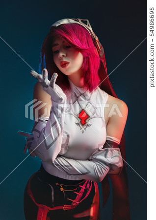 Studio portrait. Gothic anime character rosary sexy killer woman with pink hair in red and white. In a sexy pose on a dark blue dark background Studio portrait. Gothic anime character rosary sexy killer woman with pink hair in red and white. In a sexy pose on a dark blue dark background 84986698