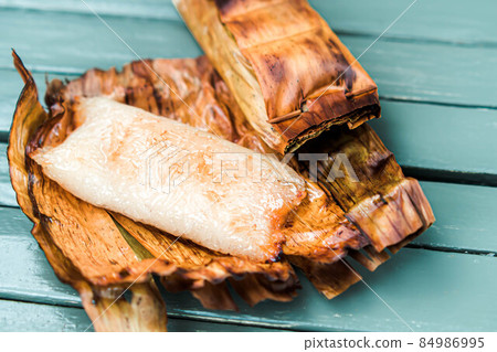 Thai traditional dessert. Grilled Taro Stuffed Coconut Sticky Rice 84986995
