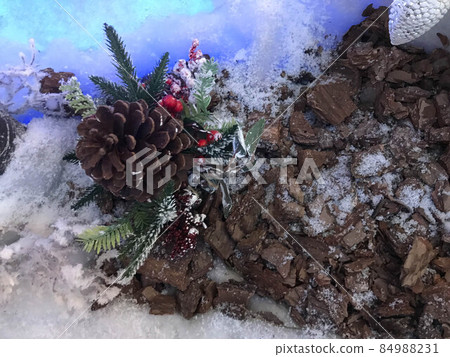 Christmas or New Year blurred snow background with festive fir tree and pine cones, selective focus 84988231