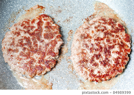 Grilled hamburger cutlets burger patties on frying pan. closeup Grilled hamburger cutlets burger patties on frying pan. closeup 84989399