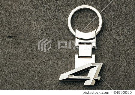 Metal number Four car key on dark concrete background Metal number Four car key on dark concrete background 84990090