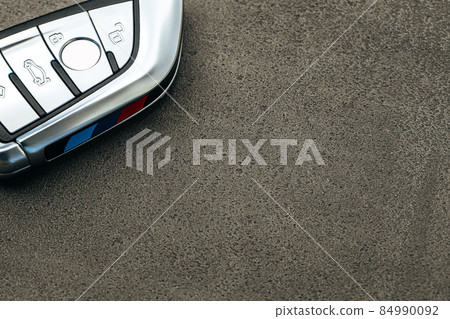 Modern automobile car key on black concrete background Modern automobile car key on black concrete background 84990092