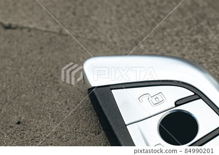 Modern automobile car key on black concrete background 84990201