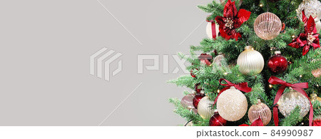 Christmas tree red ornaments baubles lights. Long banner 84990987