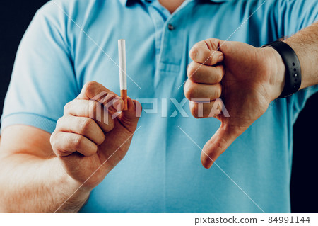 Man in blue short gesturing smoking is bad 84991144
