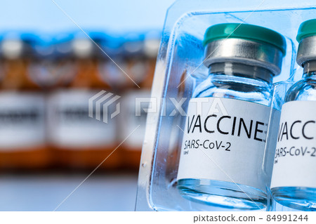 Vaccine vials of Sars-cov-2 on table in laboratory . 84991244