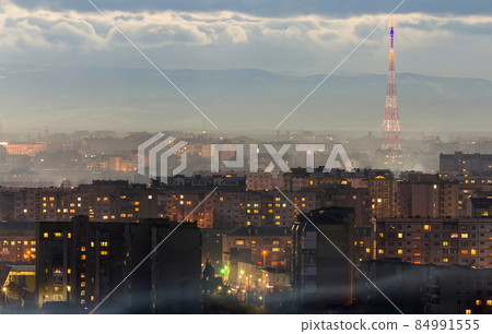 Panorama of night aerial view of Ivano-Frankivsk city, Ukraine. Scene of modern night city with bright lights of tall buildings. Residential quaters and construction cranes in modern urban space. 84991555