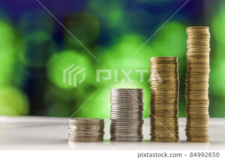 Growing coins stacks with green and blue sparkling bokeh background. Financial growth, saving money, business finance wealth and success concept. Growing coins stacks with green and blue sparkling bokeh background. Financial growth, saving money, business finance wealth and success concept. 84992650