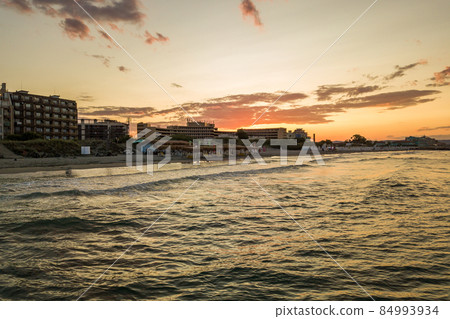 Aerial view of Pomorie city that is located on Black Sea shore. Top view of sand beaches with many hotel buildings and tourist infrastructure. Aerial view of Pomorie city that is located on Black Sea shore. Top view of sand beaches with many hotel buildings and tourist infrastructure. 84993934