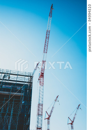 Large-scale building construction site Building silhouette, crane and blue sky a-4 Matte feeling 84994810