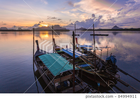 Ban Sam Chong Tai and colorful sunrises that emerges behind the giant limestone mountains, Thailand Ban Sam Chong Tai and colorful sunrises that emerges behind the giant limestone mountains, Thailand 84994911