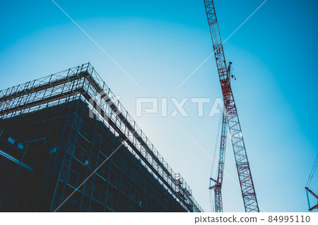 Large-scale building construction site Building silhouette, crane and blue sky e-4 matte feeling 84995110