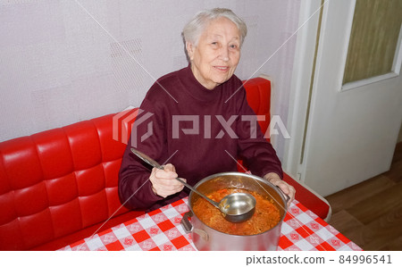 Senior woman cooking in the kitchen healthy Senior woman cooking in the kitchen healthy 84996541
