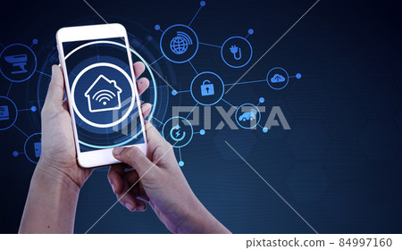 Hand of woman or man holding smartphone in house with icons in modern life internet of things, smart home technology. concept of automation. the new innovation of the future in living room 84997160