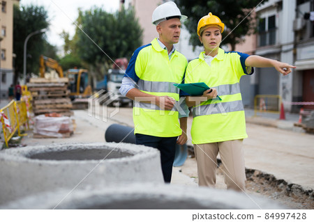 Civil engineers checking work process in construction site Civil engineers checking work process in construction site 84997428