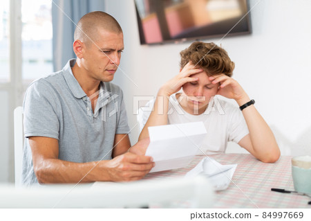 Son and his father reading letter 84997669