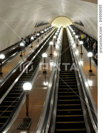 Long escalator at Kiyevskaya station, metro station with luxurious decoration, Russia, Moscow Long escalator at Kiyevskaya station, metro station with luxurious decoration, Russia, Moscow 84999095