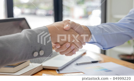 Business personage handshake, Asian women congratulate on being a corporate partnership with European male investors, Relationship of friendship, Sign language greetings, Business negotiation. 84999220