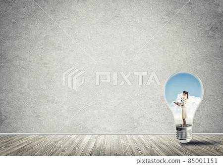 Businesswoman trapped in bulb Businesswoman trapped in bulb 85001151