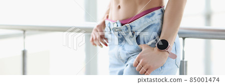 Beautiful pumped up press of young woman in jeans closeup Beautiful pumped up press of young woman in jeans closeup 85001474