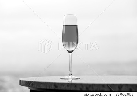 Champagne glass and copy space that blends into the black and white landscape Champagne glass and copy space that blends into the black and white landscape 85002095