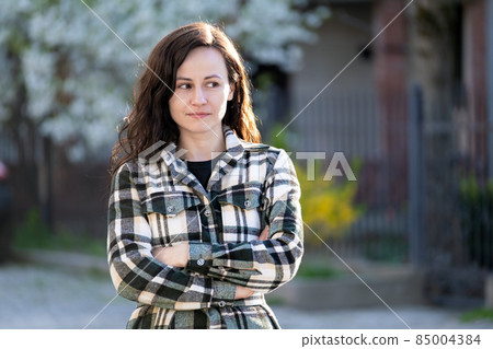 Portrait of pretty young woman relaxing outdoors on warm spring sunny day. Portrait of pretty young woman relaxing outdoors on warm spring sunny day. 85004384