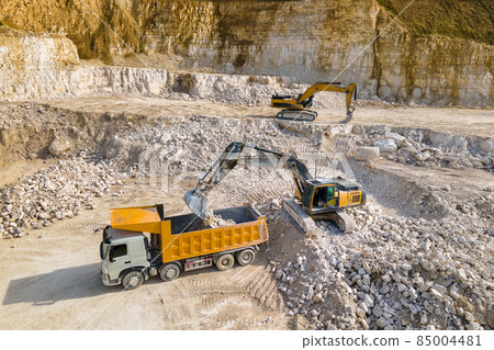 Open pit mining of construction sand stone materials with excavators and dump trucks. 85004481