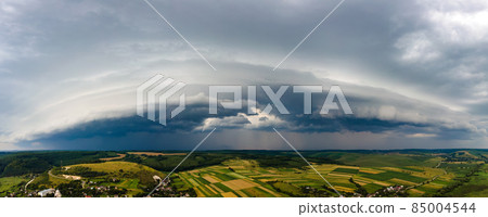 Landscape of dark clouds forming on stormy sky during thunderstorm over rural area. Landscape of dark clouds forming on stormy sky during thunderstorm over rural area. 85004544