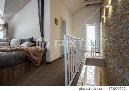 Interior of a contemporary home with spacious hallway, bedroom doors and staircase railing in modern style. 85004652