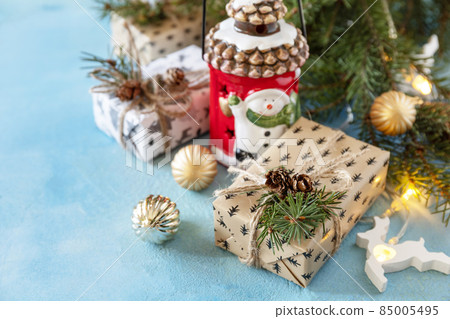 Holiday Xmas concept. Christmas card with fir tree, christmas lights and decor on a blue stone background. Copy space. Holiday Xmas concept. Christmas card with fir tree, christmas lights and decor on a blue stone background. Copy space. 85005495