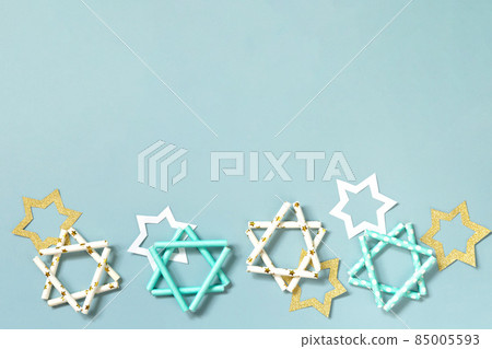 Jewish holiday Hanukkah. Symbol of Hanukkah star of David on a blue background. Top view flat lay. Copy space. 85005593