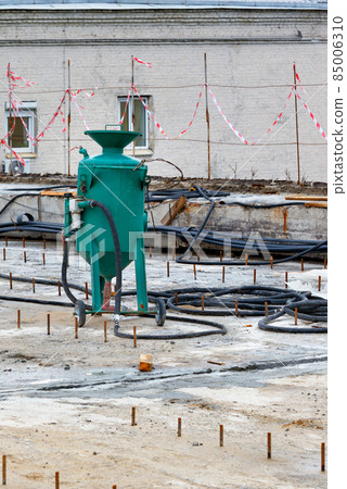 Construction sandblasting machine on the job site for the processing of metal structures. Vertical image. 85006310