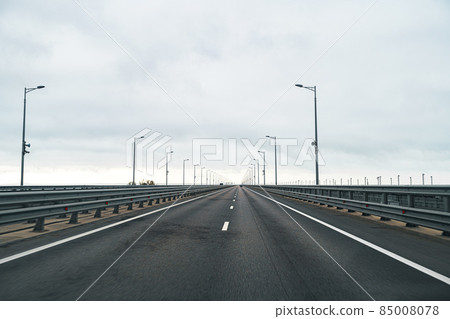 Empty highway with asphalt road and cloudy sky 85008078