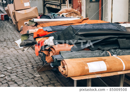 Natural leather of high quality in rolls for sale in the street, leather manufactory. Materials for handmade leather craft and sewing furniture. Selective focus 85009508