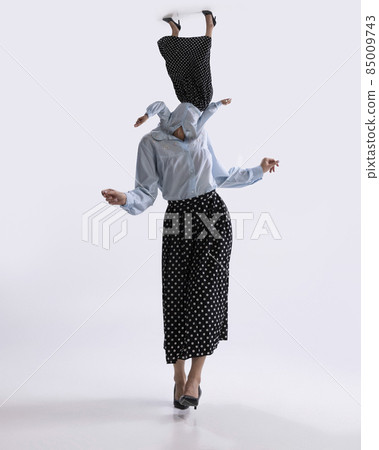 Surreal artwork with portrait of young dancing woman dressed in 50s, 60s style with own body instead head isolated on white background Surreal artwork with portrait of young dancing woman dressed in 50s, 60s style with own body instead head isolated on white background 85009743