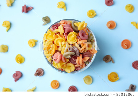 Flat lay composition with vegetable vesuvio pasta on light blue background Flat lay composition with vegetable vesuvio pasta on light blue background 85012863