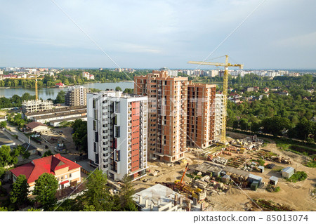 Aerial view of tall residential apartment buildings under construction. Real estate development. Aerial view of tall residential apartment buildings under construction. Real estate development. 85013074