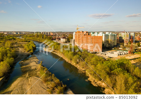 Aerial view of tall residential apartment buildings under construction and Bystrytsia river in Ivano-Frankivsk city, Ukraine. Aerial view of tall residential apartment buildings under construction and Bystrytsia river in Ivano-Frankivsk city, Ukraine. 85013092