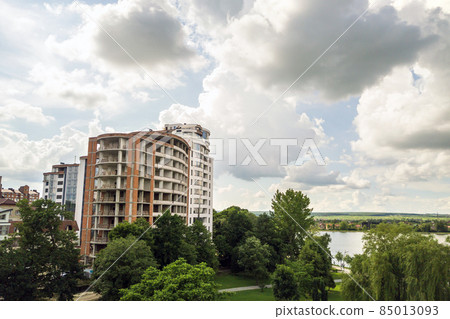 Aerial view of tall residential apartment building under construction. Real estate development. Aerial view of tall residential apartment building under construction. Real estate development. 85013093
