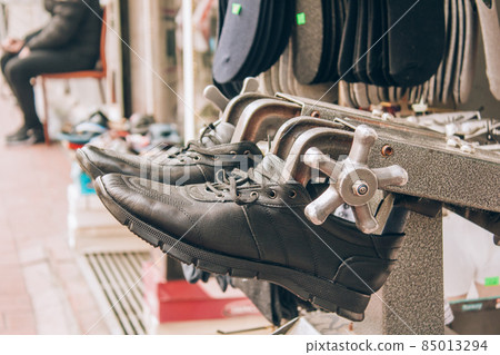 Footwear stretching in shoe repair shop. Close up view. Selective focus Footwear stretching in shoe repair shop. Close up view. Selective focus 85013294