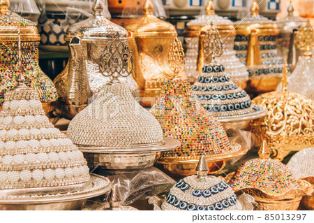 Traditional turkish dessert serving bowls in souvenir shop decorated with multicolored crystals. Popular souvenir and present from Turkey. Selective focus 85013297