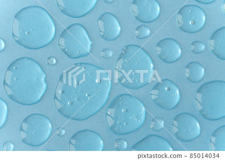 Blue doses of acid, hyaluronic moisturizing serum or gel on a monochrome background. Abstract backdrop pattern. Beauty product wallpaper. Cosmetics or healthcare protection concept.  85014034