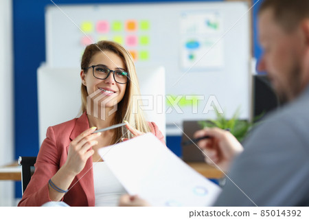 Cheerful optimistic woman listen to colleague report, office worker in suit Cheerful optimistic woman listen to colleague report, office worker in suit 85014392