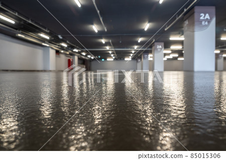 Clean and glossy flooring of the Parking lot in the parking building 85015306