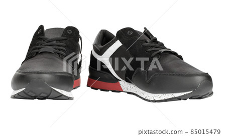 Pair of new non-branded black athletic trainers or trainers isolated on white background.  85015479