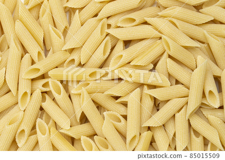 Pennette rigate. Background of raw pasta. 85015509